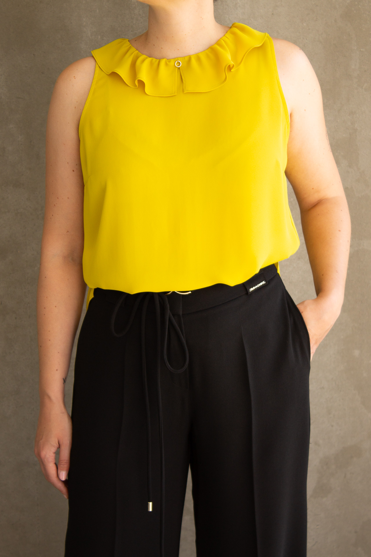 Sleeveless top with ruffle