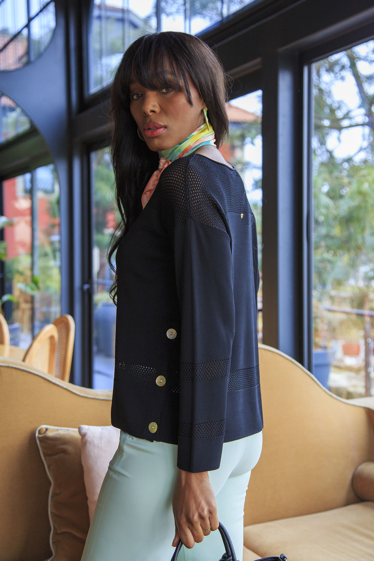 Knitted jumper with perforated areas