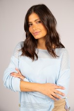 Knitted jumper with perforated areas
