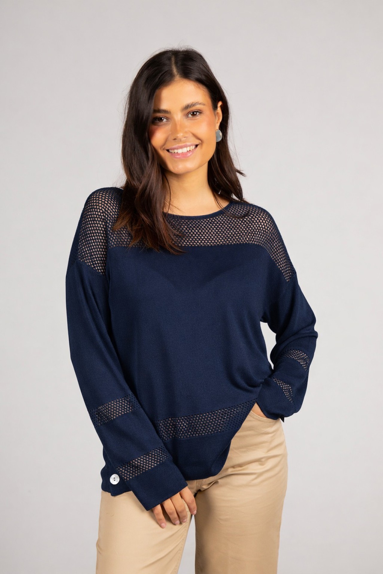 Knitted jumper with perforated areas