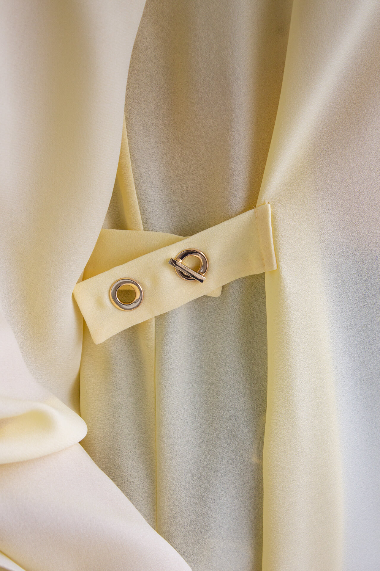 Blouse with gold eyelets